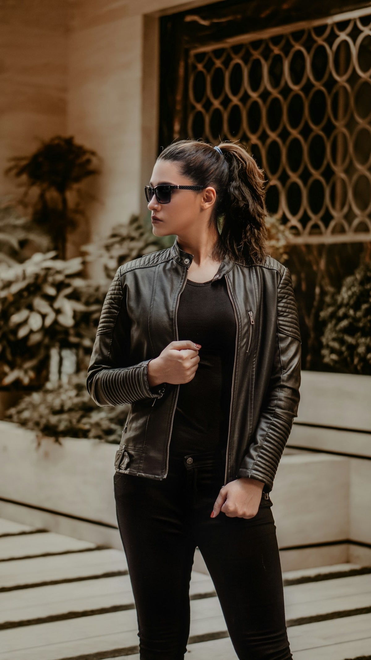 Woman in oversized black leather jacket