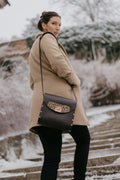 Woman in camel coat walking