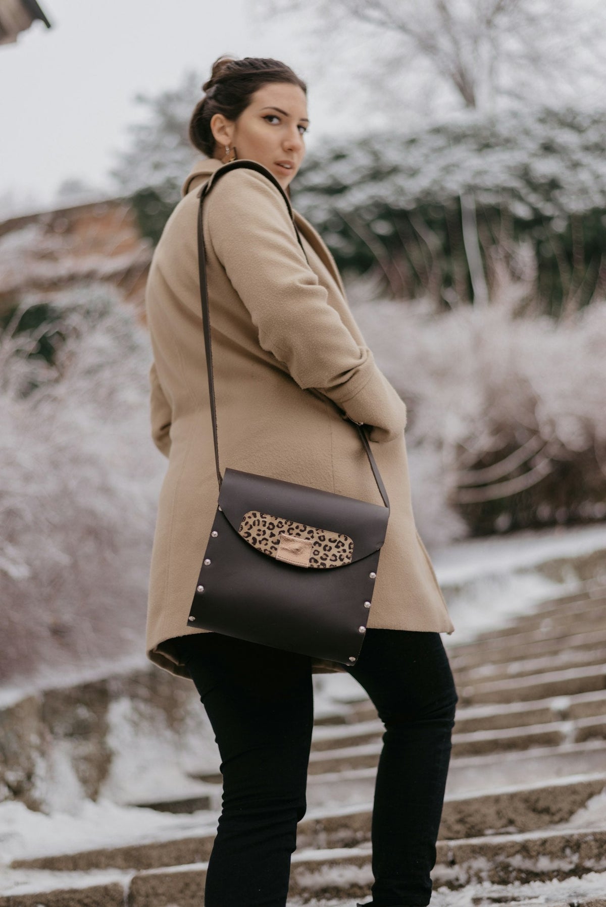 Woman in camel coat walking