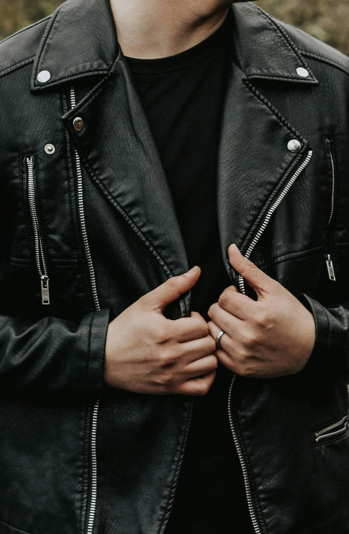 Man holding a leather racer jacket