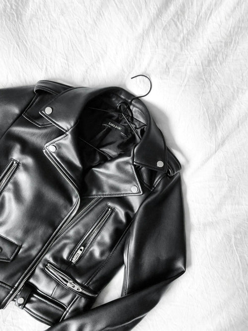 Black leather zip jacket flat lay